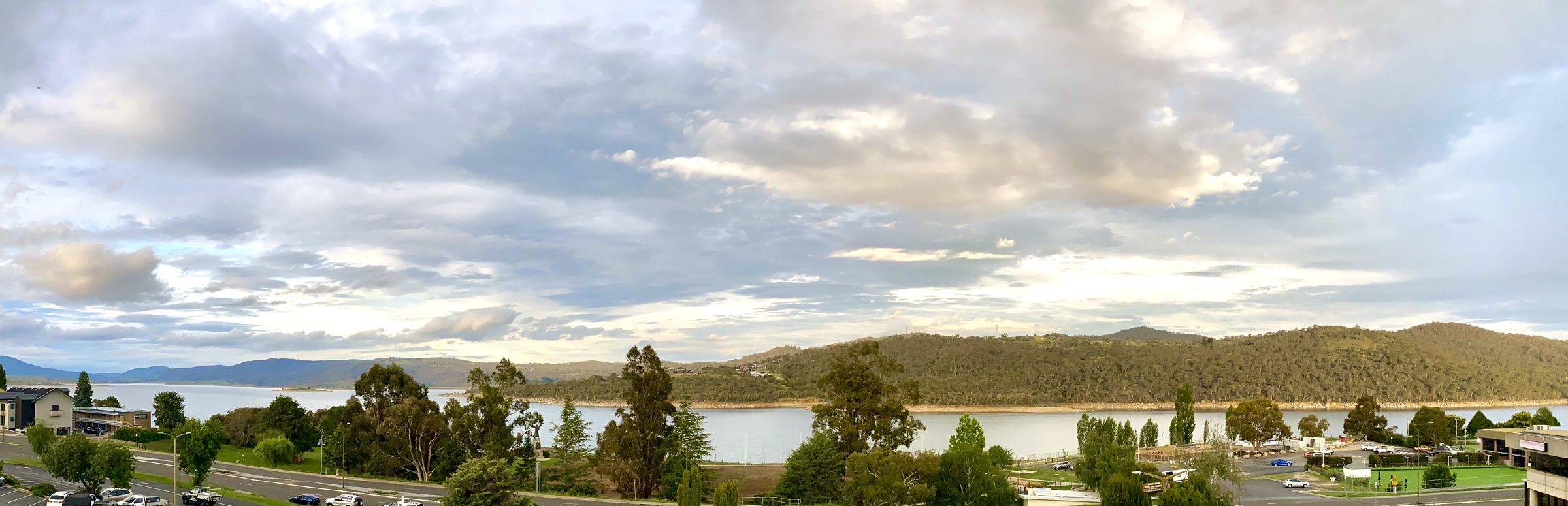 Panorama of Lake Jindabyne and the hills from the apartment, under a big sky