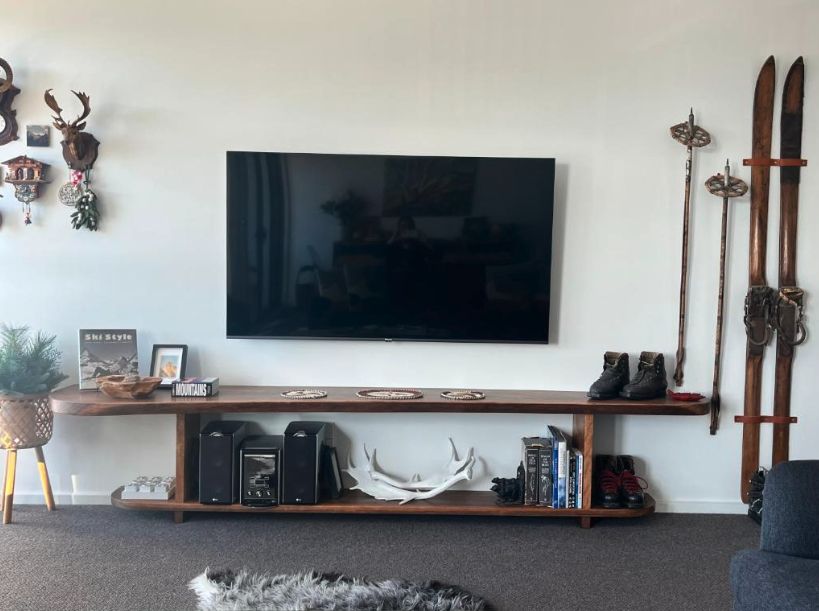 Timber TV console with vintage skis, poles and old hiking boots